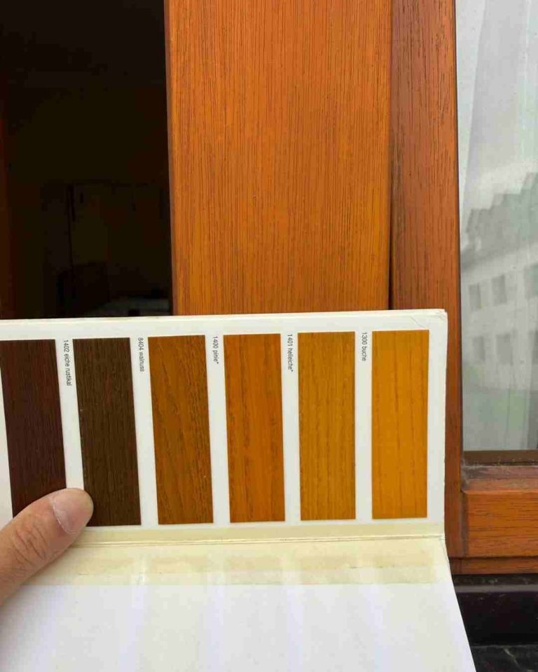 Farben zur Lackierung Farbsammlung in verschiedenen Holznuancen neben einem Fensterrahmen.